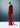 Red evening gown with a long train on a gray background