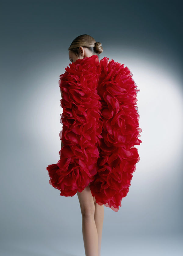 Red floral dress on a model against a gray background
