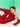 Person wearing a red outfit with gloves against a green background