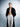 Person wearing a black robe over white pants on a gray background